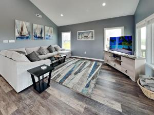 a living room with a couch and a flat screen tv at Fish Tales in Lamar