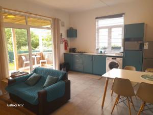 a living room with a couch and a kitchen at Les Pêcheurs in La Gaulette