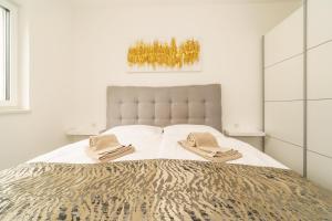 Ένα ή περισσότερα κρεβάτια σε δωμάτιο στο Apartmani Dujak 2