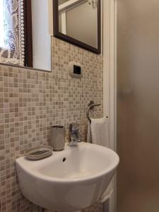 a white sink in a bathroom with a mirror at Il PETTIROSSO in Galbiate +13 photos