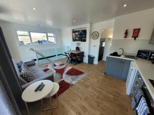 a living room with a couch and a table at City Centre Wallgate Apartments- Step back into Roman history in Colchester