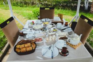 a table with a breakfast of eggs and bread at Xanbulan İstirahət Mərkəzi in Lankaran +29 photos