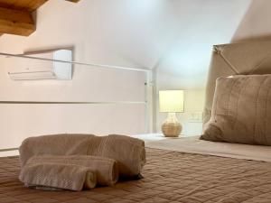 a bedroom with a bed and a lamp on a floor at Casa Noemi Scicli in Scicli