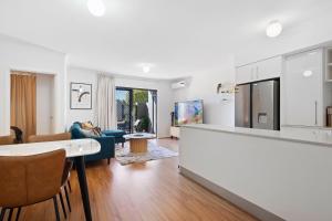 a kitchen and living room with a table and chairs at Comfort & Convenience - A Sepal Stay in Perth