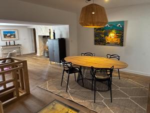 a dining room with a wooden table and chairs at Maison Châteaux Lavandes in Grignan