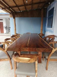 a wooden dining table with chairs around it at Pinlac Private Resort in San Fabian