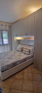 a bedroom with a large bed in a room at Casa Cala Sardegna Budoni Residence con Piscina in Budoni +19 photos