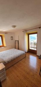 Posteľ alebo postele v izbe v ubytovaní Appartamento Comelico Dolomiti