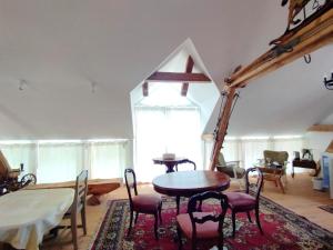 a dining room with a table and chairs and a window at Unik Villa Brunnen Blick mit offenem Dachstuhl in Sankt Andreasberg +21 photos