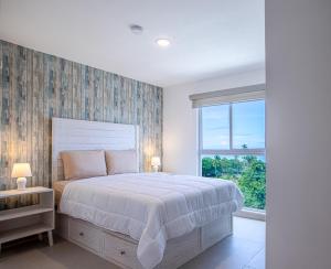 a bedroom with a large bed and a large window at Viva Jaco in Jacó +49 photos
