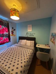 a small bedroom with a bed and a desk at Private Room in Newmarket in Newmarket