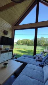 a living room with a couch and a large window at Domek Na Łące in Silna Nowa +30 photos