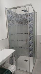 a shower with a glass door in a bathroom at Sa Mesaluna Naturhouse in Ilbono +41 photos