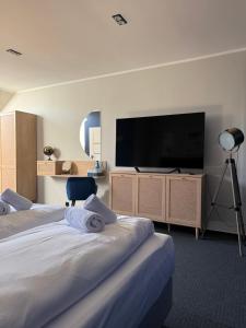 a hotel room with two beds and a flat screen tv at VistaMare in Władysławowo