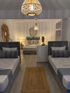 a living room with two beds and a couch at Chrysa House in Kamares