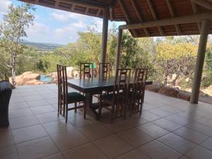 a dining room table and chairs on a patio at Zebula private villa 206 in Vosburg