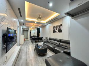 a living room with a couch and a table at Royal City Apartment Ha Noi by Luxe Hospitality in Hanoi