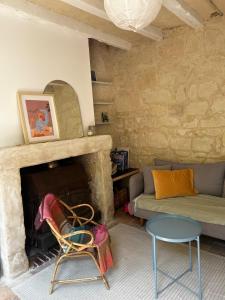 a living room with a couch and a fireplace at La maison familiale des bords de Loire in Turquant