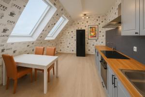 a kitchen with a table and chairs and a refrigerator at Ferienwohnung Danny in Marienheide