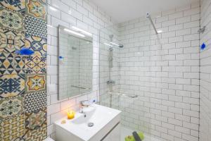 a bathroom with a sink and a mirror at Townhouse Aqua-Maris by Algarve Vacation in Tavira +42 photos