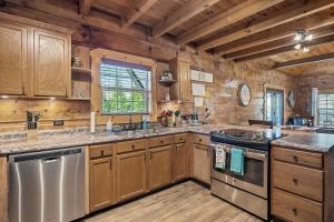 a kitchen with wooden cabinets and a stove top oven at Deer Run - A Peaceful cabin hideaway in Alpine