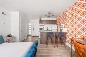 a living room with a bed and a kitchen at LOFT LE RÉTRO du Centre-Ville in Quebec City