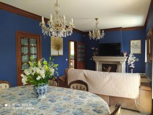 a dining room with a table with a vase of flowers at Casa de São Braz in Landim