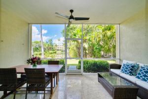 a living room with a table and a couch at Laguna | Relaxing Family Oasis in Seven Mile Beach