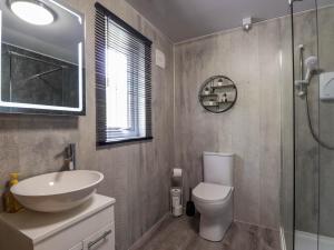 a bathroom with a sink and a toilet and a shower at Stone Water Cottage in Contin +19 photos
