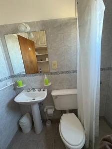 a small bathroom with a toilet and a sink at Belgrano Calidez Junin in Junín