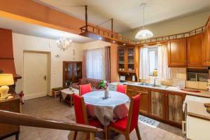 a kitchen and dining room with a table and chairs at Contessina Stamy Panoramic 360 in Ágios Matthaíos