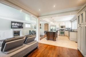 a living room with a couch and a kitchen at 3 Bedroom Luxury House in Toronto in Toronto