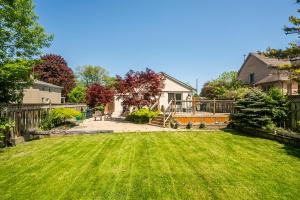 a yard with a fence and a house at 3 Bedroom Luxury House in Toronto in Toronto