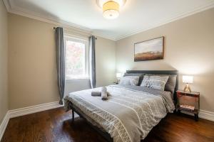 a bedroom with a bed with a teddy bear on it at 3 Bedroom Luxury House in Toronto in Toronto