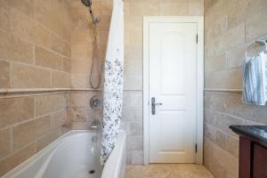 a bathroom with a bath tub and a sink at 3 Bedroom Luxury House in Toronto in Toronto +34 photos