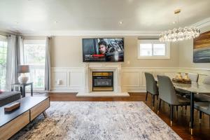 a living room with a fireplace and a tv on the wall at 3 Bedroom Luxury House in Toronto in Toronto