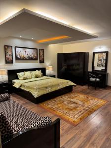 a bedroom with a large bed and a piano at Luxury Apartment in Mall Road Dalhousie in Dalhousie