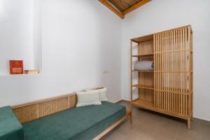 a room with a couch and a book shelf at Lapis Domus Milos in Plaka Milou