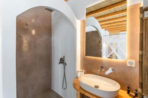 a bathroom with a sink and a mirror at Lapis Domus Milos in Plaka Milou +50 photos