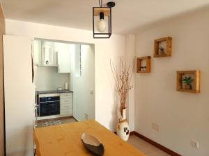 a kitchen with a wooden table in a room at Casa frente al mar en Boiro in Magdalena