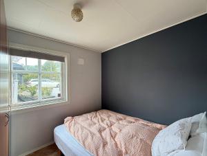 a bedroom with a bed and a window at Haugane in Selje
