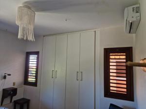 a living room with white cabinets and a window at Sobrado do Barão da Barra in Canguaretama