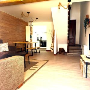 a living room with a couch and a table at Casa frente al mar en Boiro in Magdalena