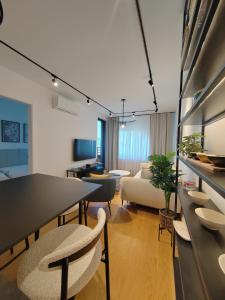 a living room with a table and chairs and a couch at New Luxury Suite with Garrage in Belgrade