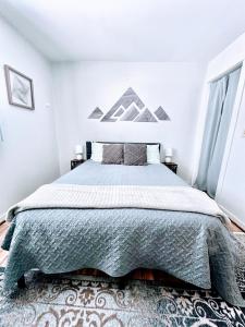 a bedroom with a large bed and a rug at Yinzer House - Whiteface Lake Placid Arcade Fun in Jay