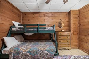a bedroom with two bunk beds and a dresser at Bear Necessities located near East Port Marina & Dale Hollow in Alpine