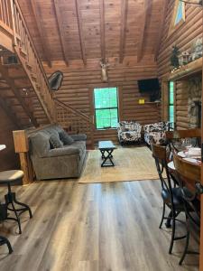 a living room with a couch and a table at Bear Necessities located near East Port Marina & Dale Hollow in Alpine
