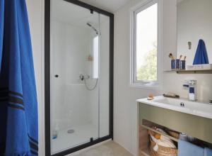 a bathroom with a shower and a sink at Camping le Frêche à l'Âne in Pléboulle +68 photos