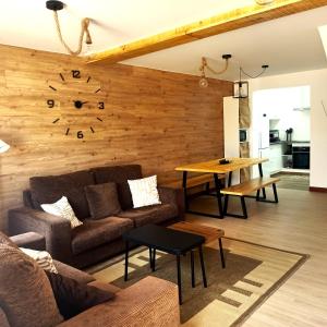 a living room with a couch and a wooden wall at Casa frente al mar en Boiro in Magdalena