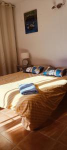 a bedroom with a bed with two towels on it at Les Tourterelles in Cadolive +4 photos